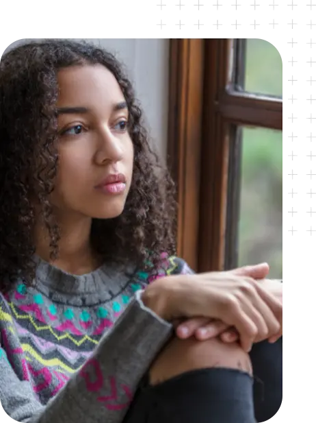 A teenage girl looking out a window