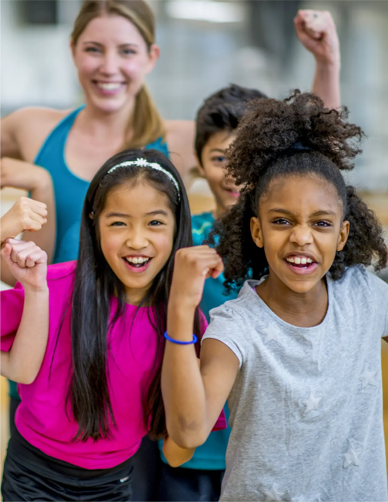 Group of excited young kids raising their fists