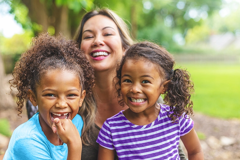 African-American toddlers with an Asian-American woman